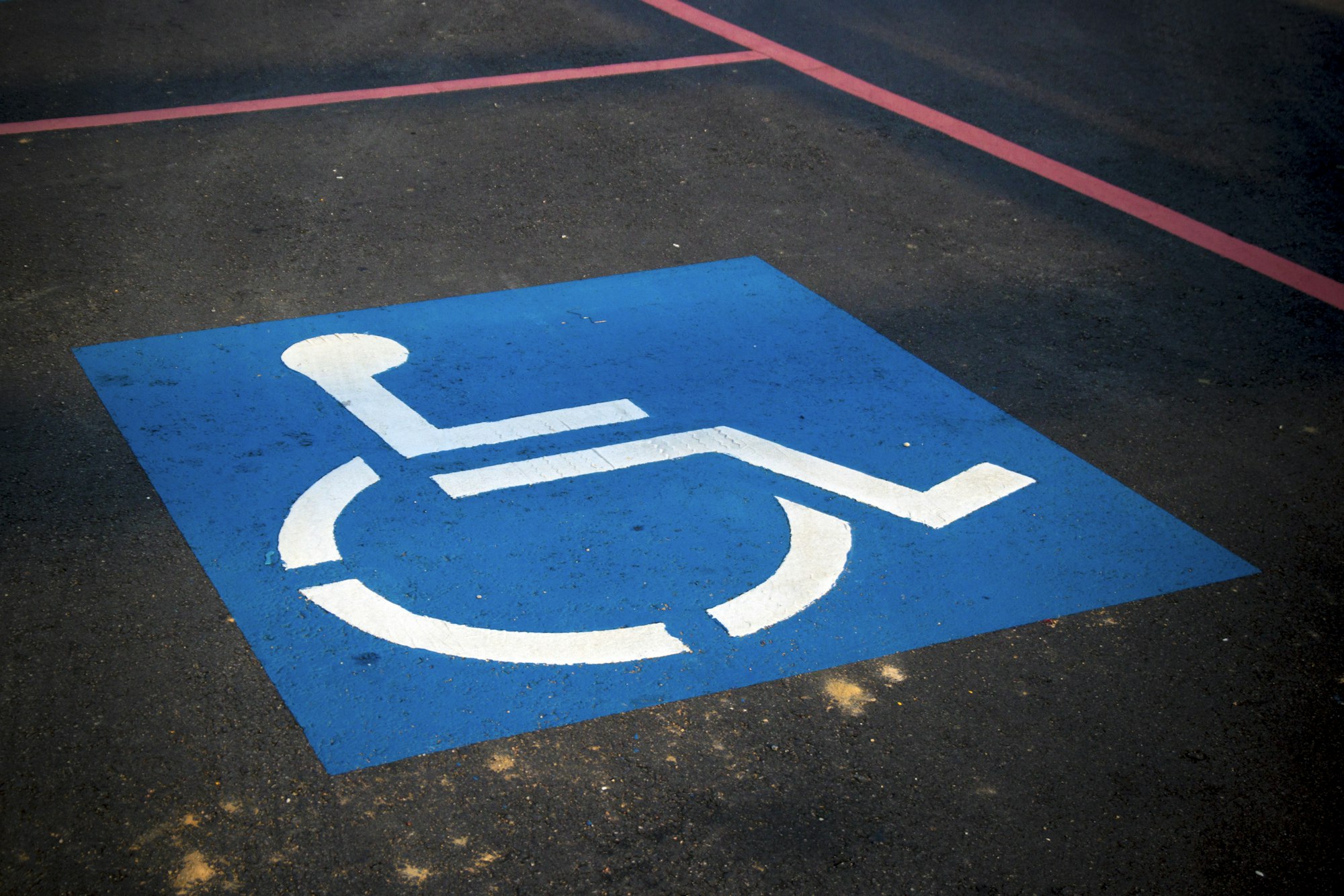 An accessible parking symbol painted on pavement