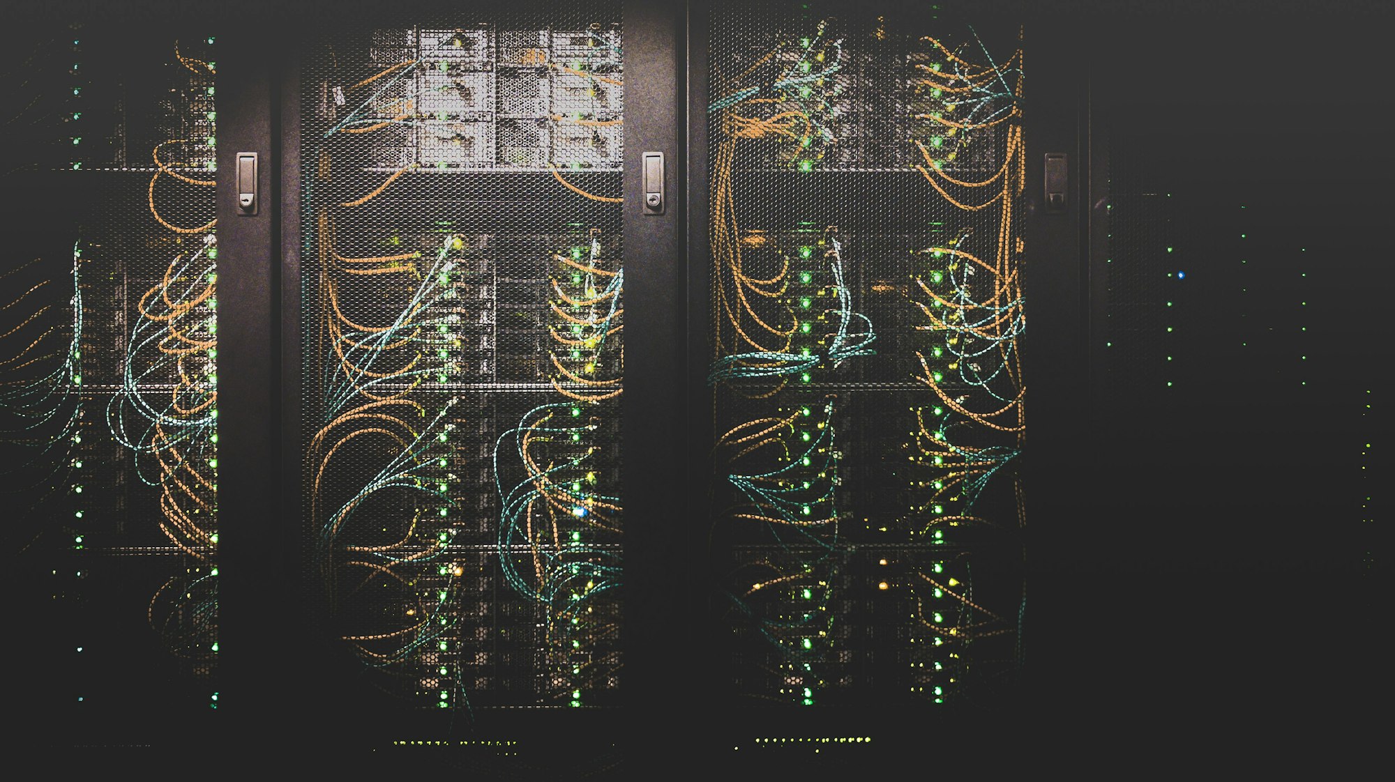 Server racks with illuminated network cables in a data center